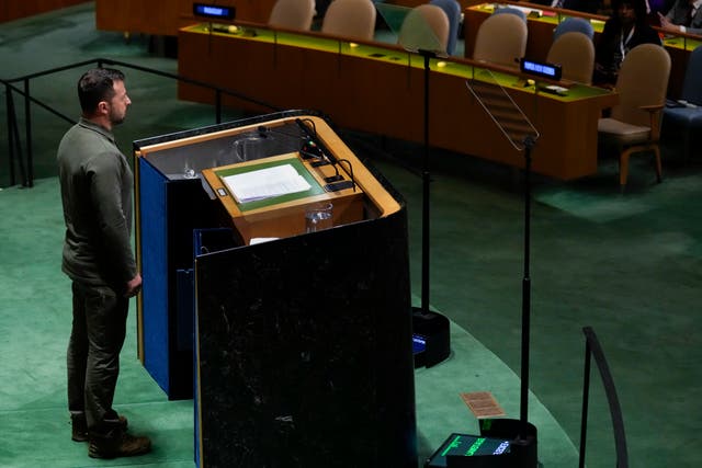 Ukrainian President Volodymyr Zelensky stands as people applaud after he addressed the UN General Assembly on Tuesday