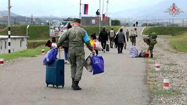 Russian peacekeepers help ethnic Armenians to get a camp near Stepanakert in Nagorno-Karabakh