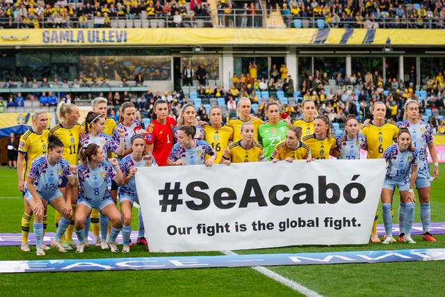 Spain and Sweden players hold a banner reading ‘#SeAcabó – Our fight is the global fight’ before their recent Nations League match