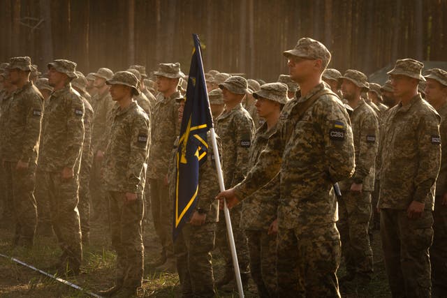 Newly recruited soldiers attend a ceremony to mark the end of their training