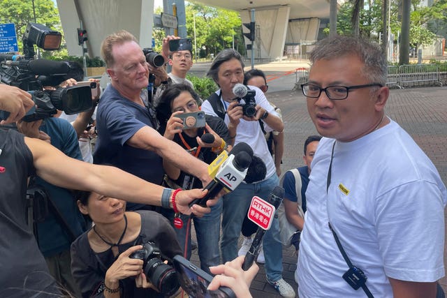 Chan, right, speaks to reporters outside court 