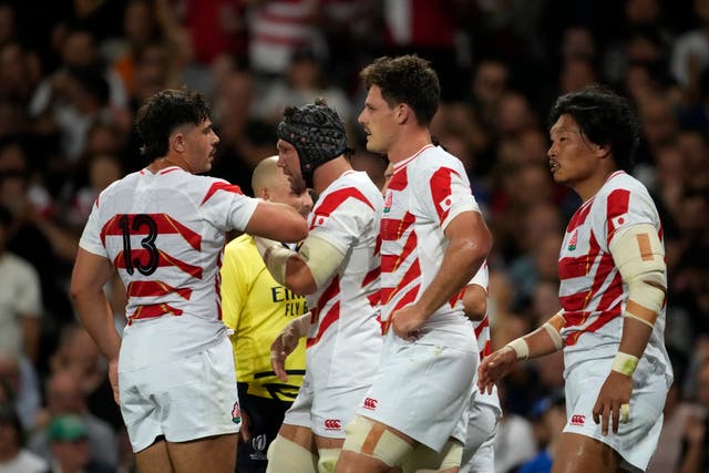Japan’s Pieter Labuschagne (second from left) celebrates scoring 