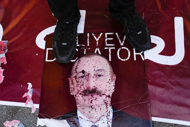 A Lebanese Armenian steps on a poster showing the President of Azerbaijan Ilham Aliyev outside the Azerbaijani embassy in Beirut