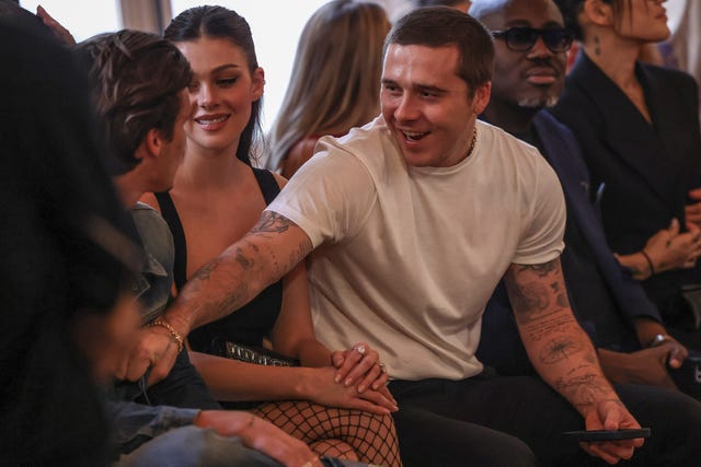 Brooklyn Beckham, from right, Nicola Peltz and Cruz Beckham attend the Victoria Beckham Spring/Summer 2024 womenswear fashion collection