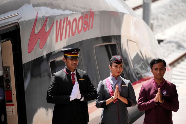 Officials stand by a high-speed train