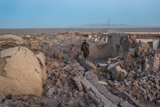 Taliban fighters guard the site of an earthquake in Zenda Jan district in Herat province 