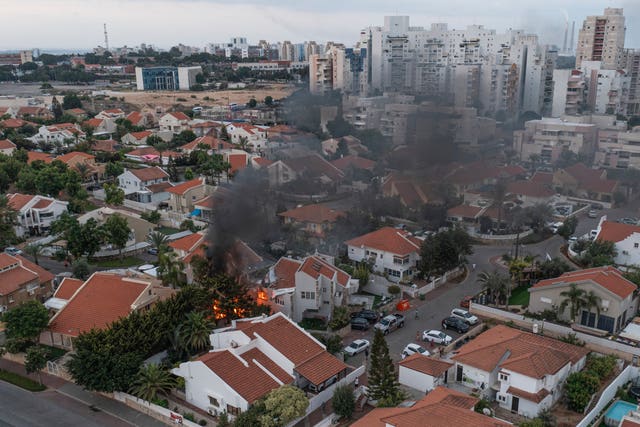 Smoke rises after a rocket fired from the Gaza Strip hit a house in Ashkelon, southern Israel