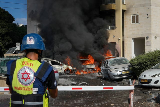 Vehicles burn after a rocket fired from the Gaza Strip hit a car park 