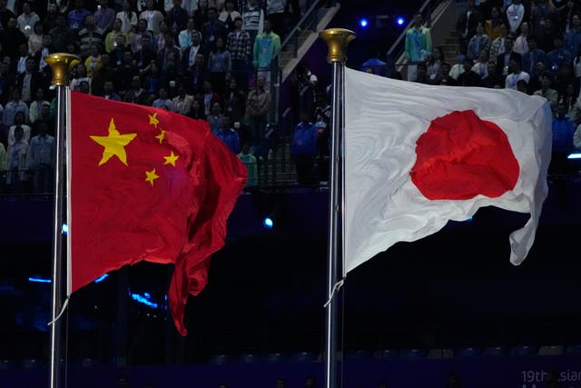 The flags of China and Japan are flown 