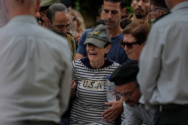 The mother of Israeli Colonel Roi Levy cries during her son's funeral at the Mount Herzl cemetery in Jerusalem on Monday
