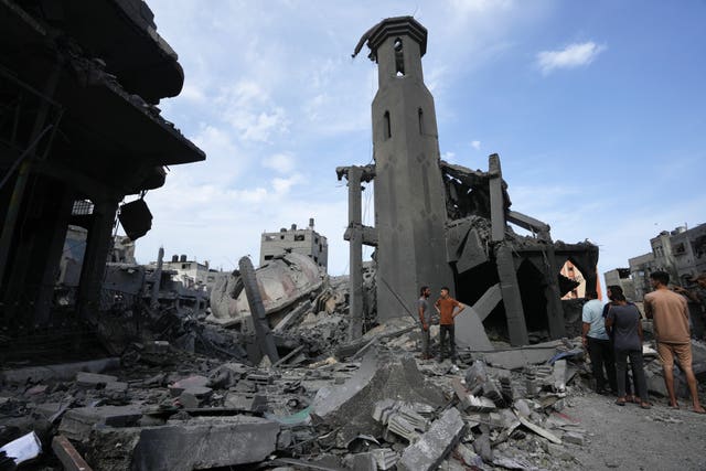 Palestinians inspect the rubble of a mosque after it was hit by an Israeli airstrike on Gaza City