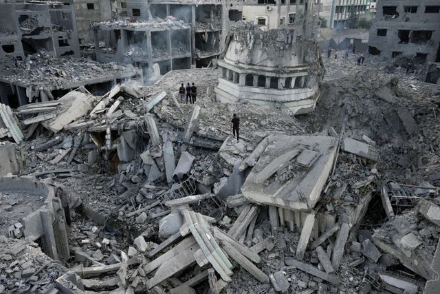 Palestinians inspect the rubble of the Yassin Mosque