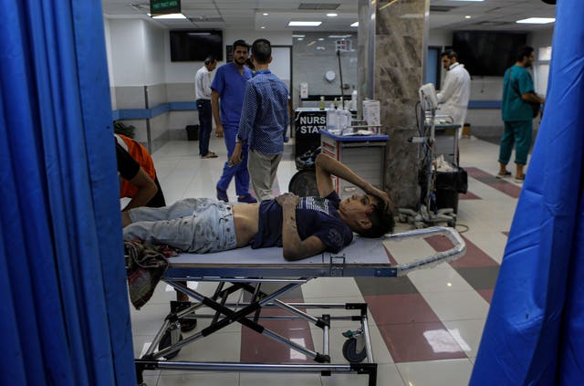 A wounded Palestinian boy arrives in the emergency room of the al-Shifa hospital following Israeli air strikes on Gaza City, central Gaza Strip