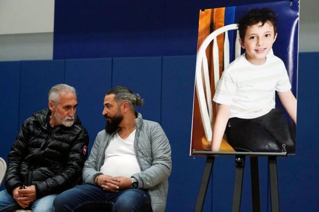 Wadee Alfayoumi’s father, Oday Al Fayoume, seated right, and his uncle Mahmoud Yousef attending a vigil for Wadee in 2023