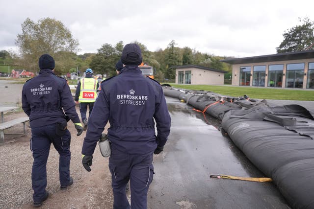 Employees from The Danish Emergency Management Agency prepare for the storm to arrive at Sonderballe Strand near Haderslev