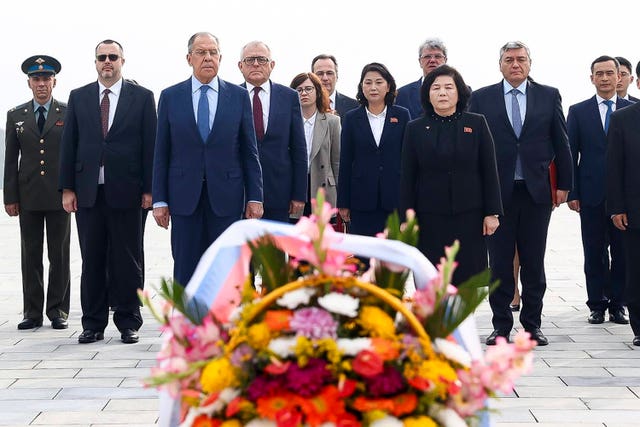 Russian foreign minister Sergei Lavrov, foreground left, and North Korean foreign minister Choe Son Hui, foreground right, attend a laying ceremony at the base of the bronze statues of North Korean late leaders Kim Il Sung and Kim Jong Il at Mansu Hill Grand Monument in Pyongyang, North Korea, on Thursday