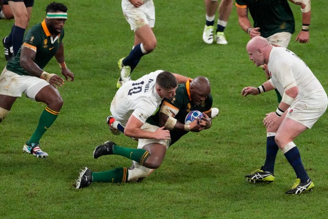 Mbongeni Mbonambi is tackled by England’s Owen Farrell