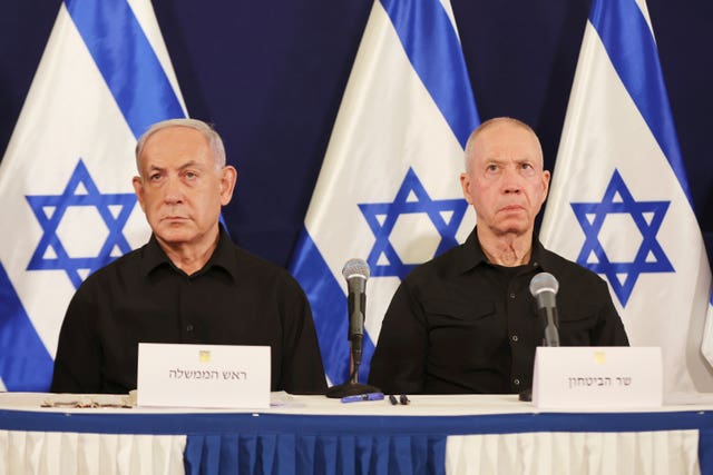 Israeli Prime Minister Benjamin Netanyahu, left, and defence minister Yoav Gallant with Israeli flags in the background