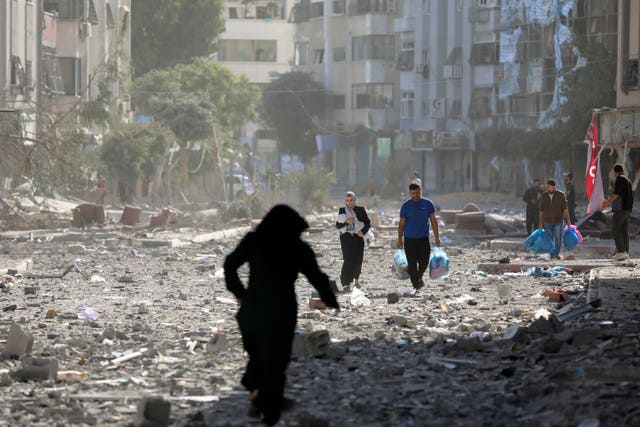 Palestinians leave their homes following Israeli bombardment on Gaza City