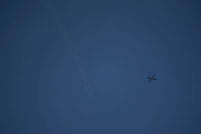 An Israeli drone and a jet fighter fly over the Gaza Strip