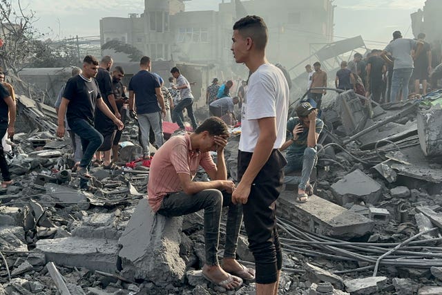 Palestinians look for survivors following an Israeli air strike in Nusseirat refugee camp, Gaza Strip