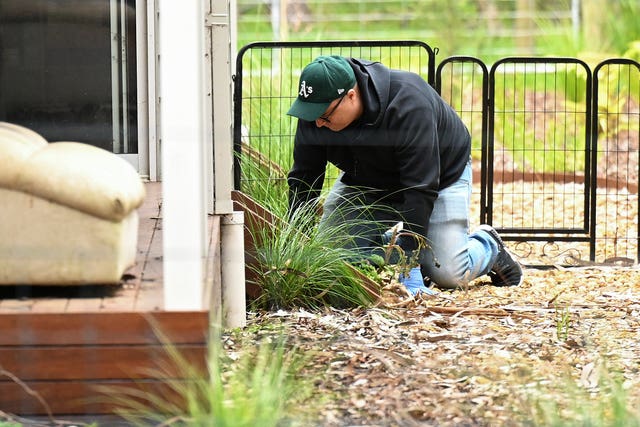 A detective searches the property of Erin Patterson