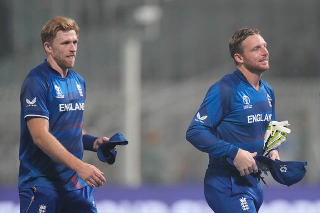 Captain Jos Buttler, right, and David Willey leave the ground after England's World Cup game against Pakistan