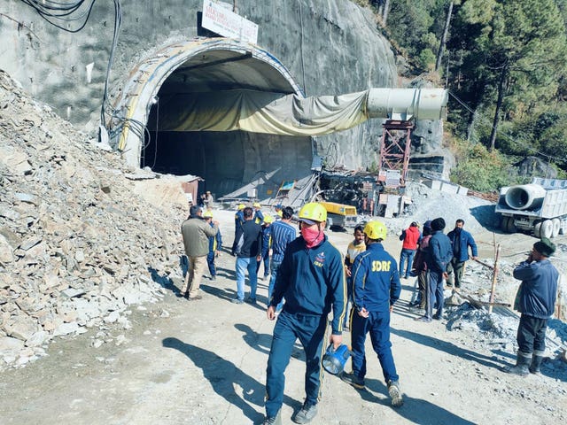 Rescuers outside the collapsed road tunnel