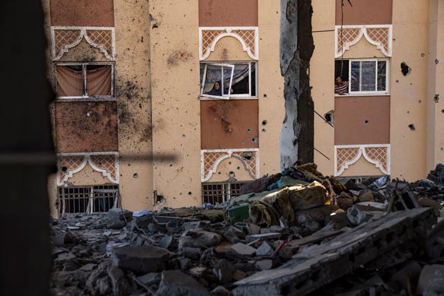 Palestinians look at destruction after an Israeli strike on the Gaza Strip in Khan Younis