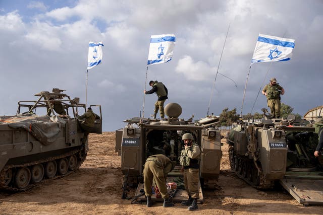 Israeli soldiers on armoured military vehicles