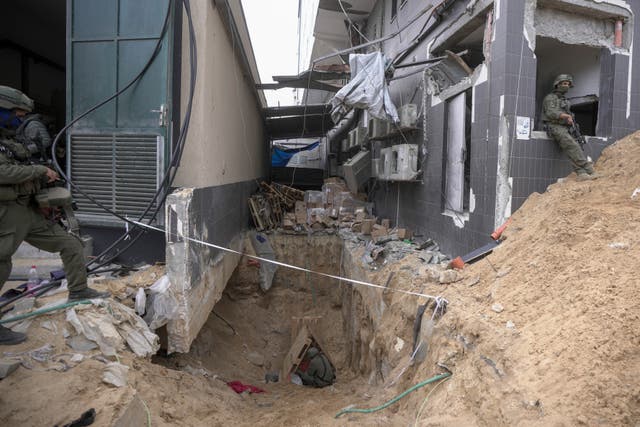 Israeli soldiers show the media an underground tunnel found under Shifa Hospital, on November 22 