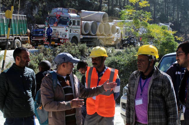 Rescuers gather at the site of the tunnel