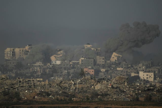 A building collapses following an Israeli air strike in the Gaza Strip, as seen from southern Israel 