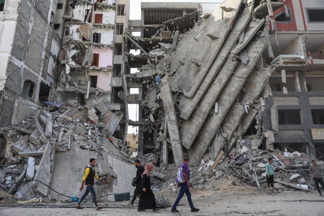 Palestinians walk through Gaza City 