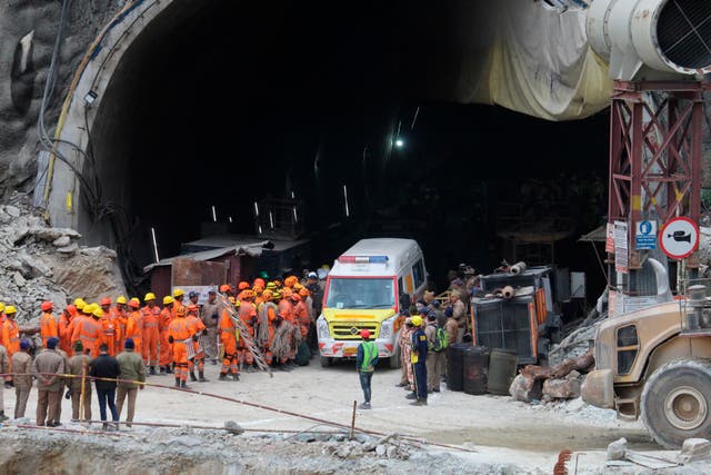 An ambulance waits to carry workers from the site of an under-construction road tunnel that collapsed in Silkyara in the northern Indian state of Uttarakhand, India