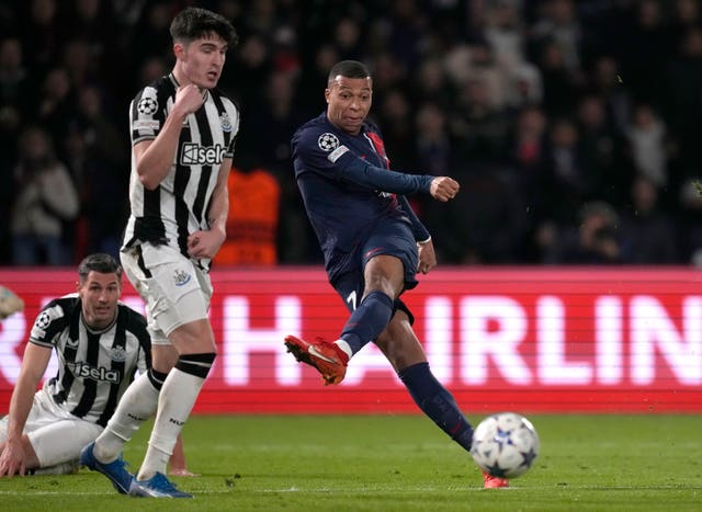 Kylian Mbappe, right, takes a shot under pressure from Tino Livramento