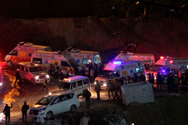 Ambulances drive past carrying workers rescued from the site of an under-construction road tunnel that collapsed in Silkyara in the northern Indian state of Uttarakhand, India