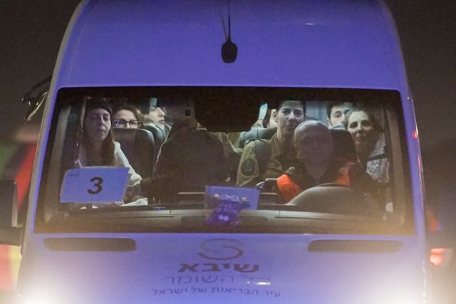 A mini-bus carrying Israeli hostages released by Hamas and Israeli military personnel arrives at the Sheba Medical Centre in Ramat Gan, Israel, early on Thursday