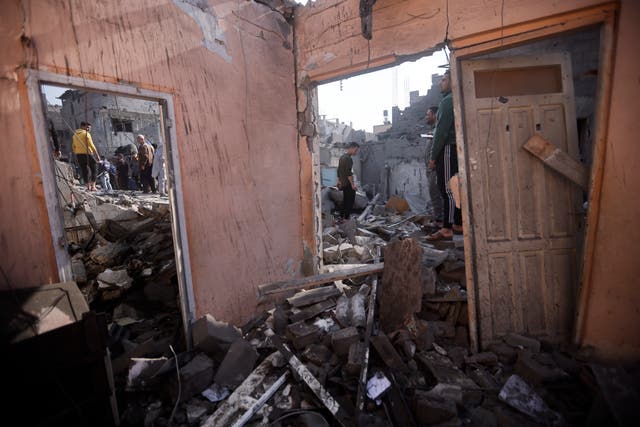 Palestinians look at destruction after the Israeli bombing In Khan Younis refugee camp in Gaza Strip