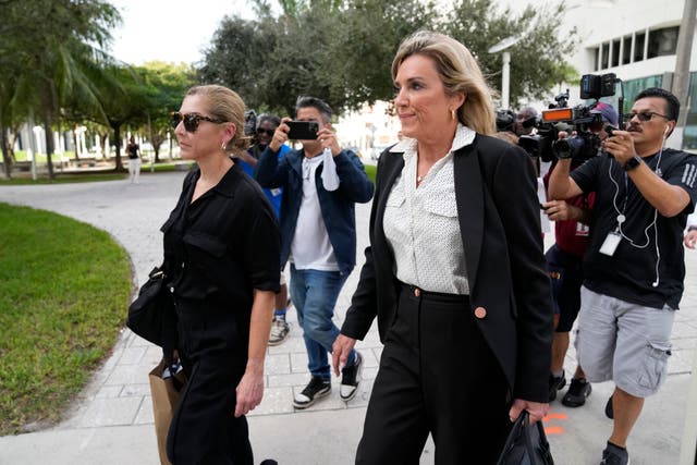 Defence lawyer Jacqueline Arango, centre, and Karla Wittkop Rocha, left, wife of Manuel Rocha, are trailed by journalists as they leave the James Lawrence King Federal Justice Building in Miami 
