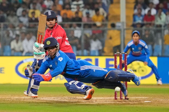 India's Richa Ghosh dives to field the ball as England’s Sophia Dunkley bats during the final T20 in Mumbai 