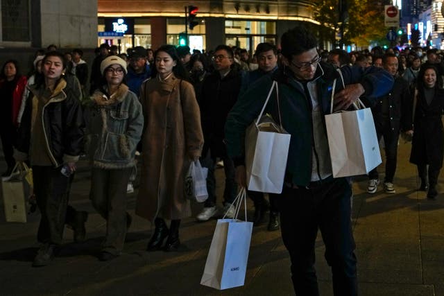 A man adjusts his shopping bag