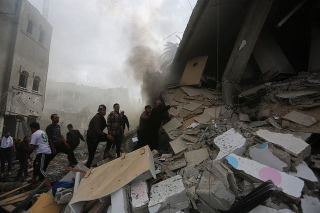 Palestinians look for the survivors of an Israeli strike in Rafah, Gaza Strip