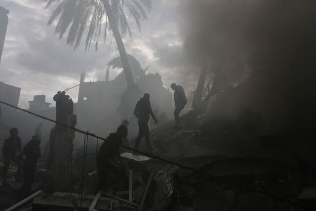 Palestinians look for the survivors of an Israeli strike in Rafah, Gaza Strip 