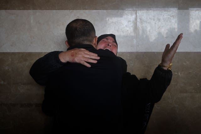 A Palestinian woman cries for her relatives who were killed in the Israeli bombardment of the Gaza Strip, at Nasser hospital in Khan Younis 