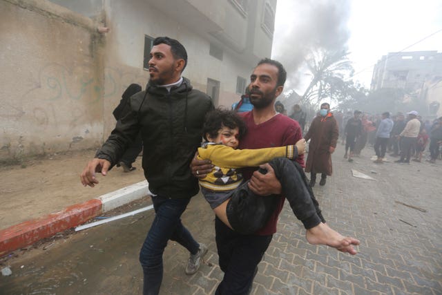 Palestinians evacuate survivors of an Israeli strike in Rafah, Gaza Strip, on Thursday