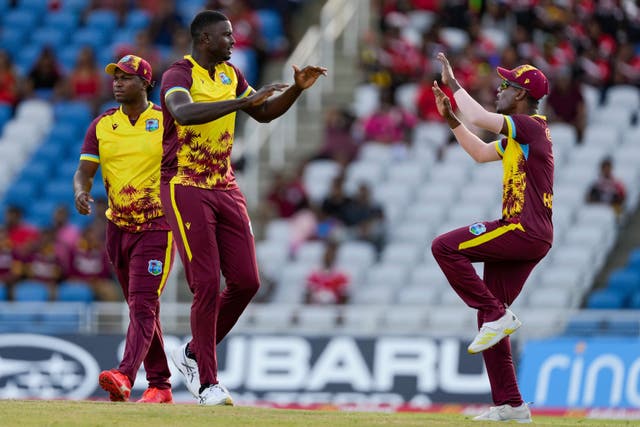 West Indies’ Jason Holder, right, celebrates with Akeal Hosein after dismissing Jos Buttler