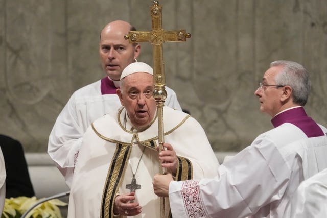 Pope Francis holds the pastoral staff as he presides over Christmas Eve Mass at St Peter’s Basilica at the Vatican