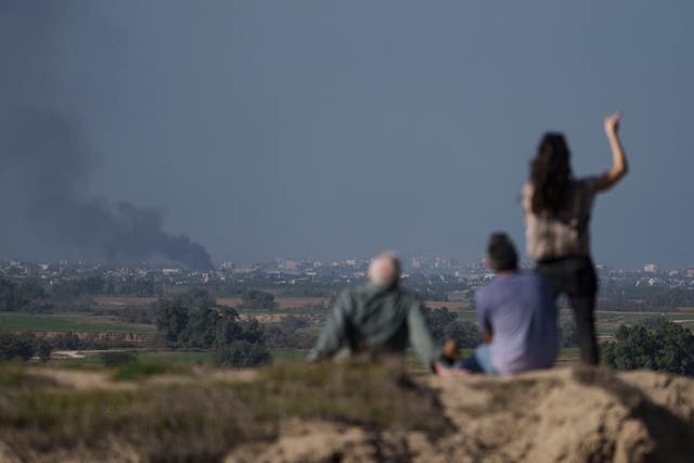 People watch a bombardment