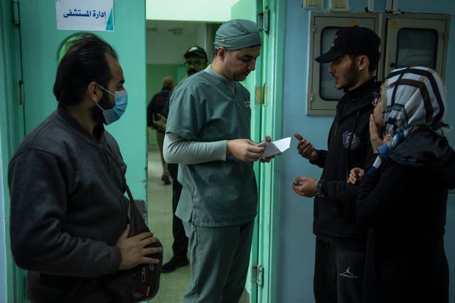 Dr Suhaib Alhamss speaks with patients at the hospital